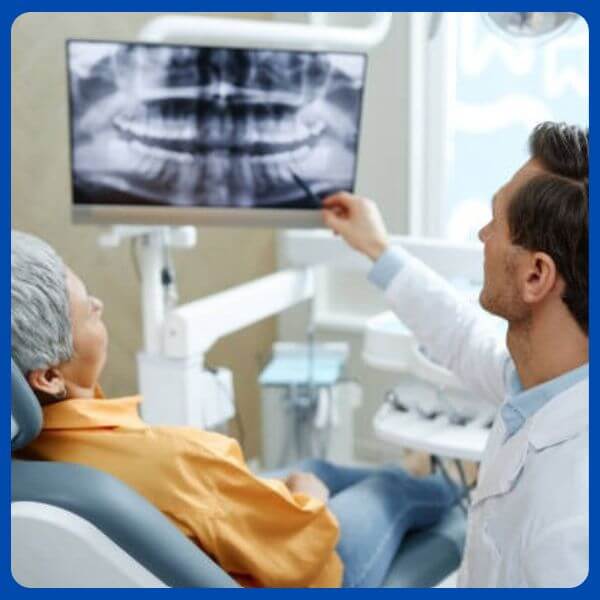 Patient learning about dental implant procedure from a dentist in Dubai – pain-free treatment explained